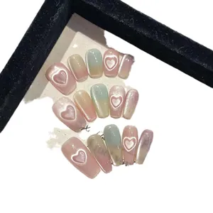 Handmade cat-eye press-on nails with 3D heart design in gradient pastel tones