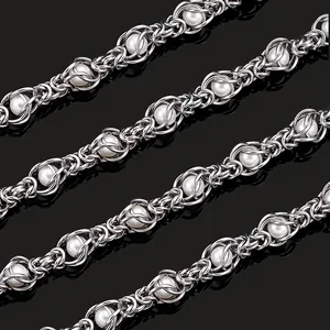 Close-up of handmade stainless steel dragon bone chain with woven white pearls