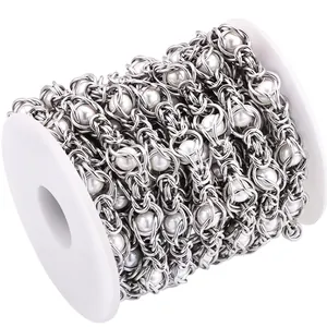 Detailed macro view of handmade stainless steel pearl chain on a white display spool