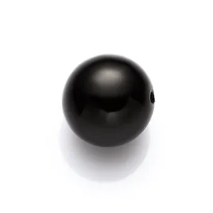 Macro shot of a high-gloss black ABS pearl bead with hole for DIY jewelry making