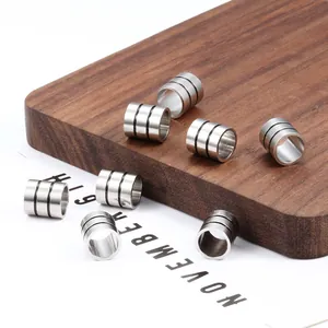 Set of polished stainless steel cylindrical beads with black triple ring engravings