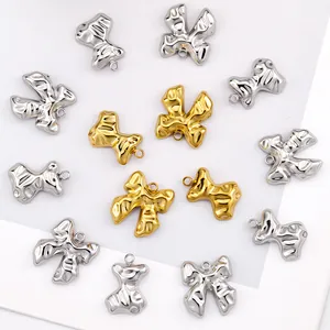 Detailed close-up of bow-shaped 18k gold and silver pendants with irregular textures