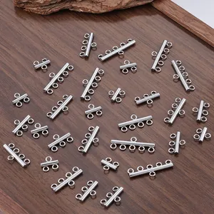 Macro view of multi-strand silver stainless steel slider tube clasps for DIY jewelry