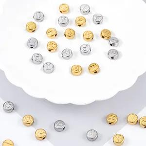 Detailed macro view of gold and silver stainless steel alphabet beads for DIY jewelry