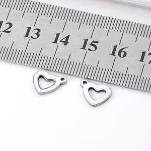 Polished hollow heart-shaped stainless steel pendant with scale for size reference