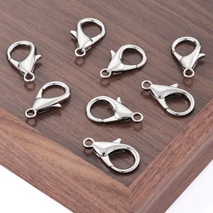 Polished 25mm metal lobster clasps for DIY jewelry making on wooden background