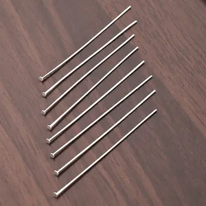 Polished stainless steel flat head T-pins for DIY jewelry making displayed on wood background