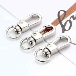 Détail de trois fermoirs mousquetons pivotants en métal argenté pour accessoires de sac