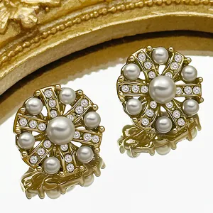 Luxury gold metal earrings with white pearls and sparkling rhinestones in radial design