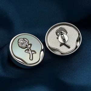 Silver flower metal button with rose carving and iridescent shell base on blue silk