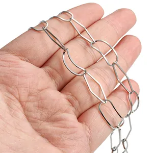 Hand holding silver geometric stainless steel chain with diamond and oval links