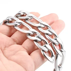 15.5mm stainless steel NK Figaro chain necklace held by hand for scale and texture detail