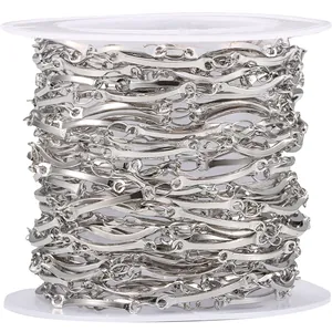 Silver stainless steel wavy link chain on white spool for DIY jewelry making