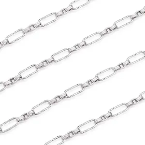 Macro view of textured silver oval links and ribbed rings for DIY jewelry chain