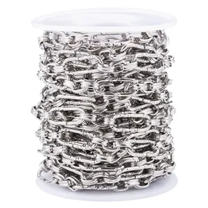 Detailed view of silver textured oval link chain wound on a white spool for DIY jewelry