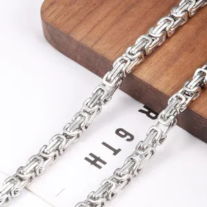 Macro shot of silver Byzantine chain links showing intricate craftsmanship and metal texture