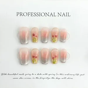 Detail of handmade blush press-on nails with pink tulips and cat-eye finish
