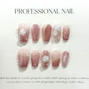 Detail of handmade press-on nails with pink gradient, white camellia, and pearls
