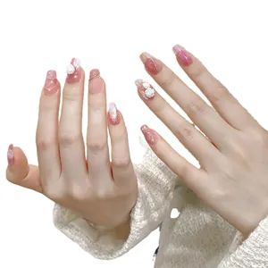 Handmade coffin press-on nails with 3D white flowers and gold wire on soft pink base