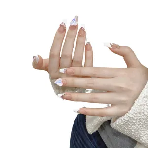 Handmade coffin press-on nails in nude pink with white French tips and glitter heart gems