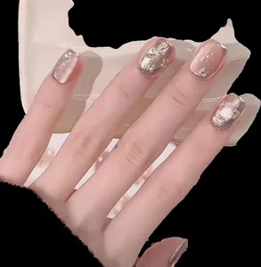 Detail of pink cat-eye press-on nails with 3D silver mirror stripes and tiny rhinestones