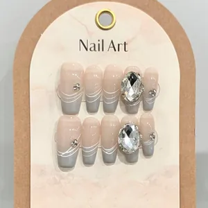 Handmade gradient press-on nails in nude and grey with white lines and crystal accents