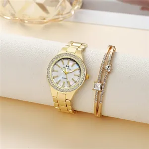 Detail of luxury gold quartz watch and matching crystal bracelet set on display