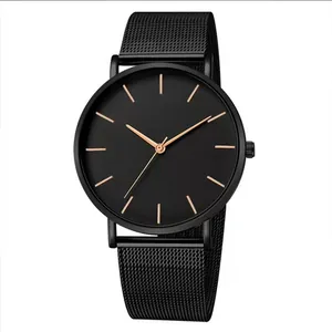 Detailed close-up of a minimalist black mesh strap watch with rose gold dial markers