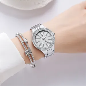 Close-up of sparkling diamond-encrusted silver watch and geometric bracelet set on wrist