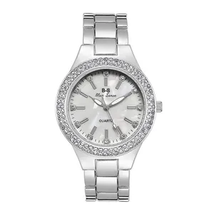 Close-up of mother-of-pearl dial and double-row crystal bezel on women's steel watch