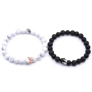 Detail view of black and white beaded crown bracelets with marble and lava stones