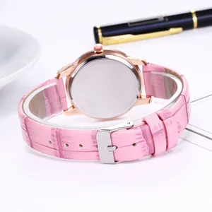Close-up of pink faux-crocodile leather strap and silver buckle of a women watch