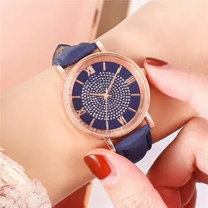 Close-up of elegant women's rose gold quartz watch with a sparkling diamond-set blue dial