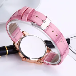 Detail view of pink crocodile pattern leather strap and rose gold watch case back
