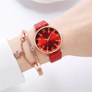 Detail of red sunburst dial watch with Roman numerals and matching star charm bracelet