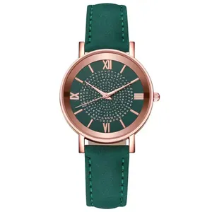 Detail of rose gold watch with emerald green starry dial and Roman numerals
