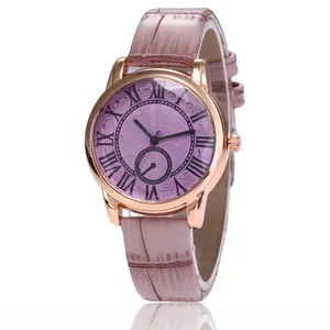 Detail of rose gold watch case with Roman numeral dial and pink crocodile leather strap