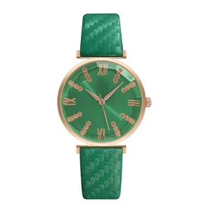 Detail of green women watch with diamond cut glass dial and textured leather strap