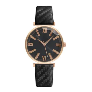 Detail of rose gold quartz watch featuring a textured black strap and iridescent dark dial