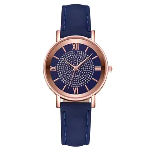 Close-up of rose gold watch case with blue leather strap and Roman numeral dial details
