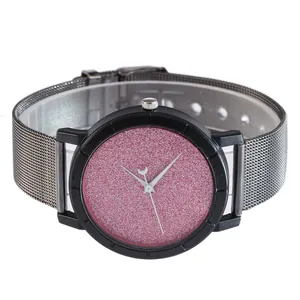Detail of pink starry glitter dial and silver mesh strap on minimalist quartz watch