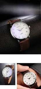 Macro view of minimalist men's quartz watch with brown leather strap and silver metal case