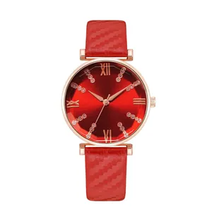 Macro view of women's watch with red sunray dial and textured red leather strap
