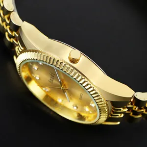 Vue macro d'une montre à quartz dorée avec lunette cannelée et index en strass brillants