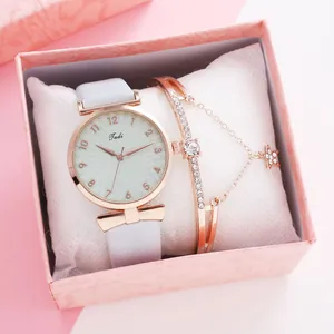 Detail of rose gold watch with grey leather strap and crystal bracelet in gift box