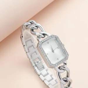 Macro view of silver square watch with diamond bezel and chunky chain link strap