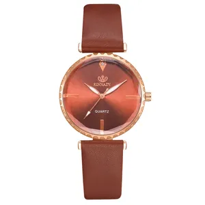 Détail macro d'une montre à quartz avec cadran brun et lunette festonnée en or rose brillant