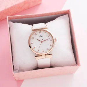 Detail of minimalist white leather watch with rose gold case in a pink gift box