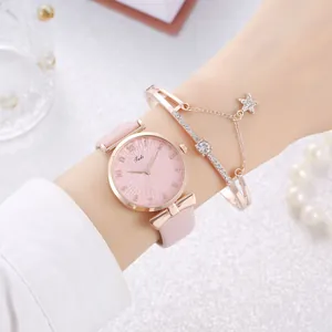 Detail of pink leather watch with sunray dial and star charm bangle on model wrist