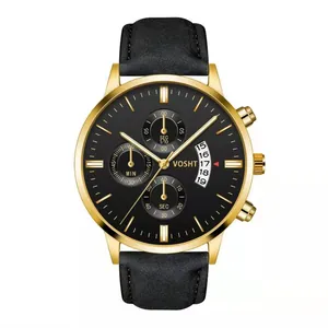 Close-up of golden chronograph watch face with black leather strap and calendar detail